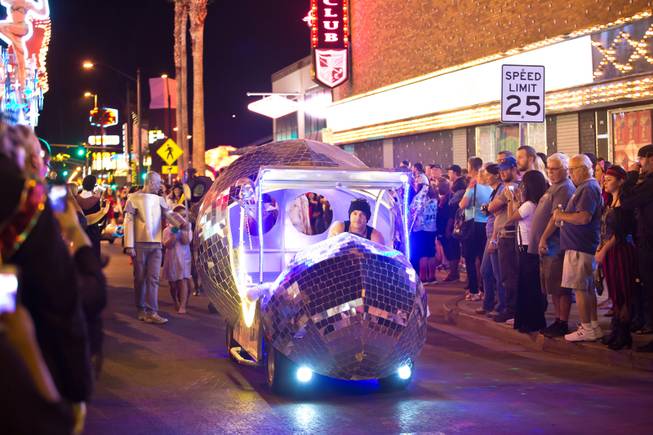 A disco ball on wheels drives down Fremont Street during the 2014 Las Vegas Halloween Parade, Friday Oct. 31, 2014.