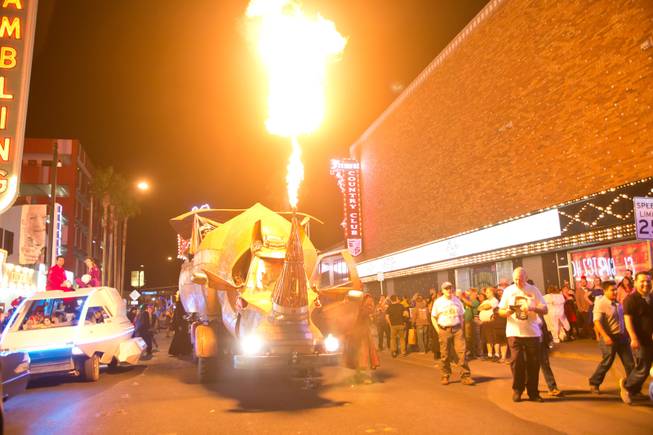A giant scrap-metal rhino breathes fire during the 2014 Las Vegas Halloween Parade, Friday Oct. 31, 2014.