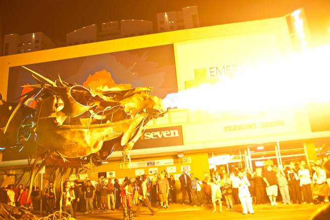 A giant scrap-metal dragon breathes fire during the 2014 Las Vegas Halloween Parade, Friday Oct. 31, 2014.
