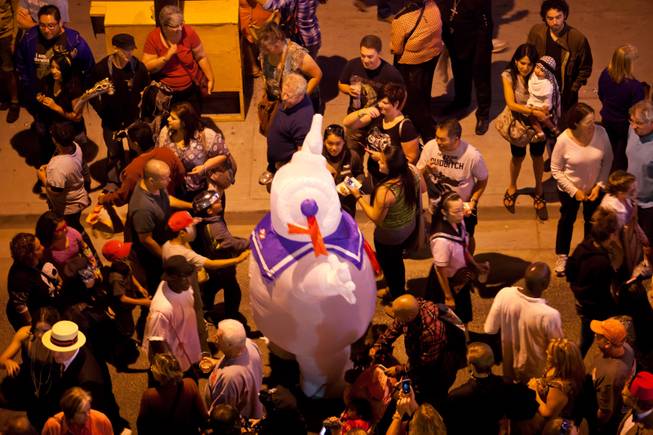 A Stay Puffed Marshmallow Man makes his way through the crowd during the 2014 Las Vegas Halloween Parade on Fremont Street, Friday Oct. 31, 2014.