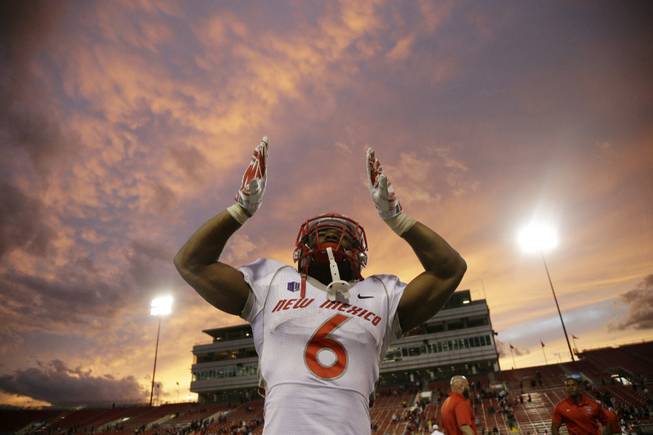 New Mexico running back Jhurell Pressley celebrates after his team defeated UNLV during their NCAA football game Saturday, Nov. 1, 2014, in Las Vegas. (AP Photo/John Locher)
