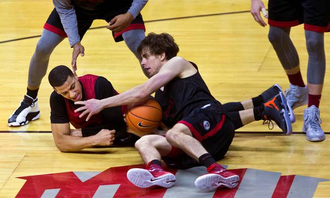 UNLV basketball player Cody Doolin #45 battles for a loose ball with teammate Kendall Smith #0 as the team holds a scrimmage on Saturday, November 1, 2014.
