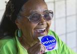 Delma Brown holds up a sticker after voting at Jo Mackey Magnet Elementary School on Tuesday, Nov. 4, 2014, in North Las Vegas.