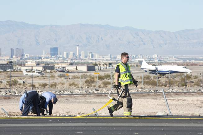 An Extra 330 Aerobatic Aircraft suffers major damage after an emergency landing on Volunteer Boulevard, a road just south of the Henderson Executive Airport, Wednesday Nov. 5, 2014. The 2 passengers on board escaped with out injury.