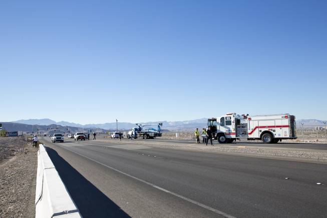 An Extra 330 Aerobatic Aircraft suffers major damage after an emergency landing on Volunteer Boulevard, a road just south of the Henderson Executive Airport, Wednesday Nov. 5, 2014. The 2 passengers on board escaped with out injury.