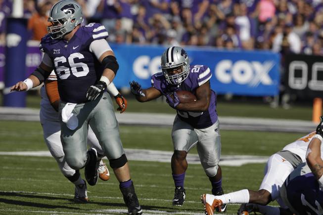 Kansas State offensive lineman BJ Finney (66) blocks for running back DeMarcus Robinson (20) during the first half of an NCAA college football game against Texas in Manhattan, Kan., Saturday, Oct. 25, 2014. (AP Photo/Orlin Wagner)