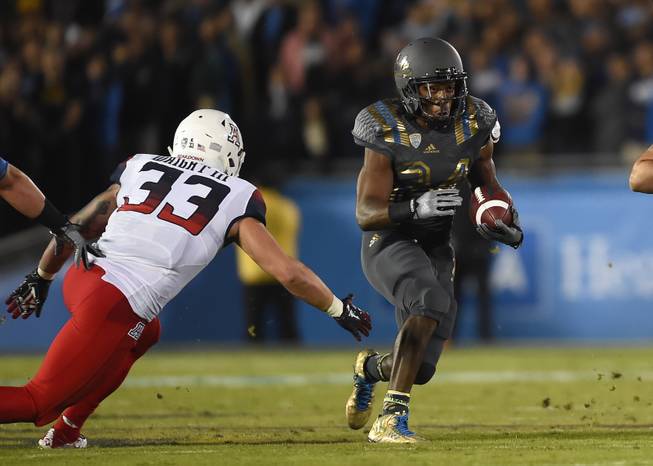 Arizona linebacker Scooby Wright III (33) attempts the tackle of UCLA running back Paul Perkins (24) during the first half of an NCAA college football game, Saturday, Nov. 1, 2014, in Pasadena, Calif. (AP Photo/Gus Ruelas)