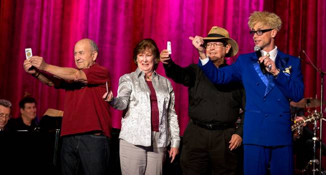 Audience volunteers Jerry Gross, Judy Vescovi and Tom Lombino assist Murray Sawchuck in a card trick during the taping of "The Dennis Bono Show" live for radio before an audience Thursday, Nov. 6, 2014. The show is produced every 2 p.m. Thursday at South Point Showroom.