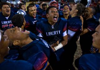 Liberty players celebrate their win over Green Valley 28-14 during their quarterfinal game on Friday, November 7, 2014.