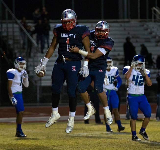 Liberty's Noah Jefferson #1 and Ethan Tuilagi #4 celebrate a late-game touchdown making it 28-14 over Green Valley on Friday, November 7, 2014.