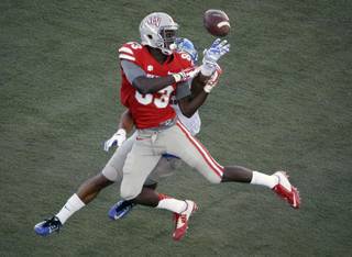 Air Force defensive back Jordan Mays, back, breaks up a potential touchdown pass intended for UNLV wide receiver Devonte Boyd (83) during the second half of an NCAA college football game Saturday, Nov. 8, 2014, in Las Vegas. (AP Photo/John Locher)