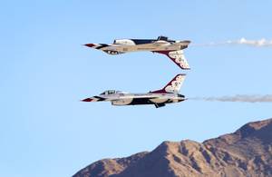 The U.S. Air Force Thunderbirds perform a Calypso Pass maneuver during the 2014 Aviation Nation open house at Nellis Air Force Base Sunday, Nov. 9, 2014.