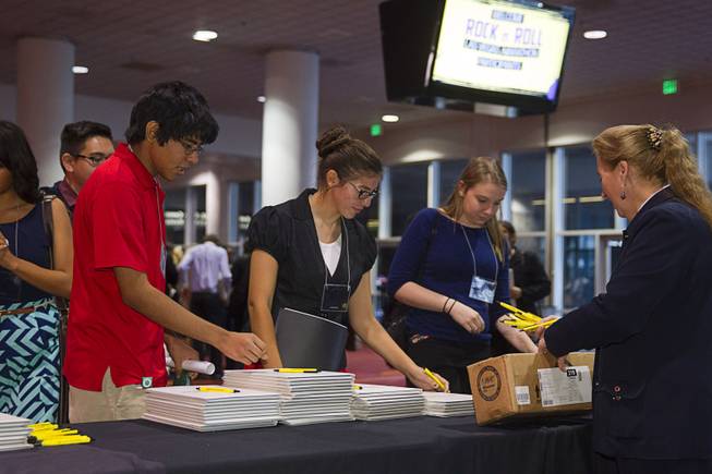 Students pick up supplies after arriving at the Las Vegas Convention Center for the 58th annual Las Vegas Sun Youth Forum Thursday, Nov. 13, 2014.