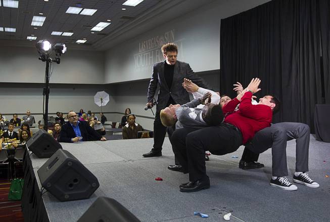 Comedian Russ Merlin performs an act with help of audience volunteers during at lunch break at the 58th annual Las Vegas Sun Youth Forum in the Las Vegas Convention Center Thursday, Nov. 13, 2014. Merlin performs in "V-The Ultimate Variety Show" at Planet Hollywood.