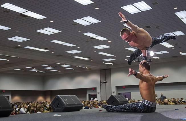 Iouri of Russia, top, and Gabor of Hungary entertain students during the 58th annual Las Vegas Sun Youth Forum at the Las Vegas Convention Center Thursday, Nov. 13, 2014. The pair are performers in "V-The Ultimate Variety Show" at Planet Hollywood.