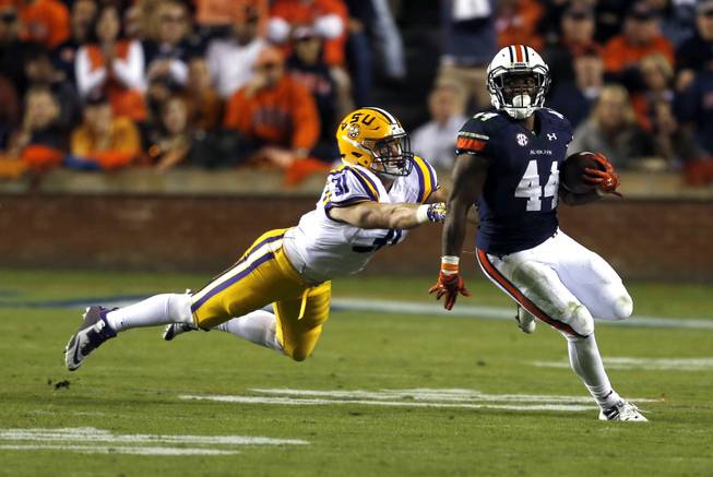 Auburn running back Cameron Artis-Payne (44) gets around LSU linebacker D.J. Welter (31) during the first half of an NCAA college football game on Saturday, Oct. 4, 2014, in Auburn, Ala. (AP Photo/Butch Dill)