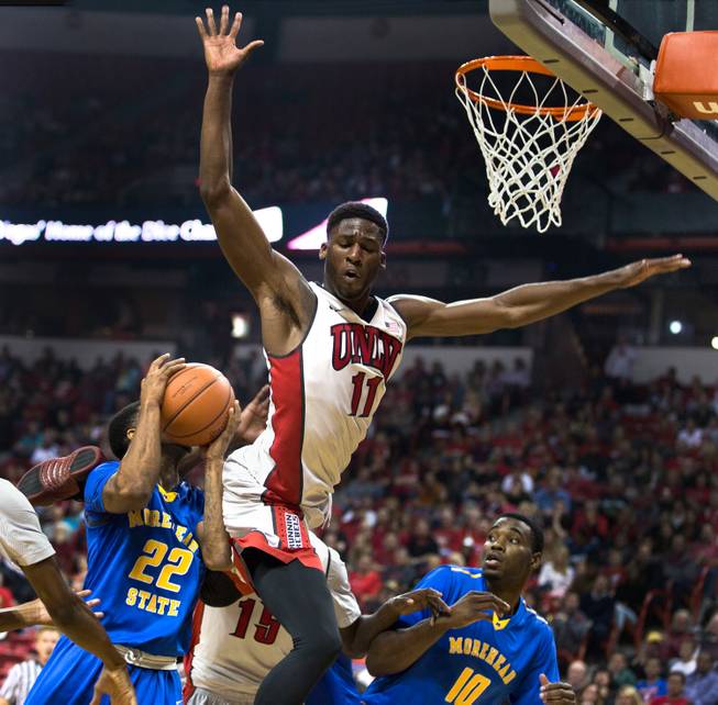 UNLV's Goodluck Okonoboh #11 gets high in the air while working to block a shot by Morehead State's Angelo Warner #22 during their home opener on Friday, November 14, 2014.