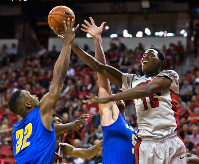 UNLV's Dwayne Morgan #15 reaches for a rebound with Morehead State's Brent Arrington #32 during their home opener on Friday, November 14, 2014.