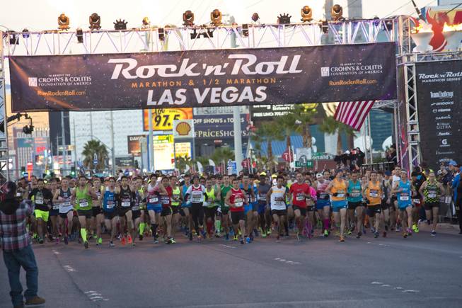 Elite runners take off during the start of the 2014 Rock n Roll Marathon Las Vegas, Sunday Nov. 16, 2014.