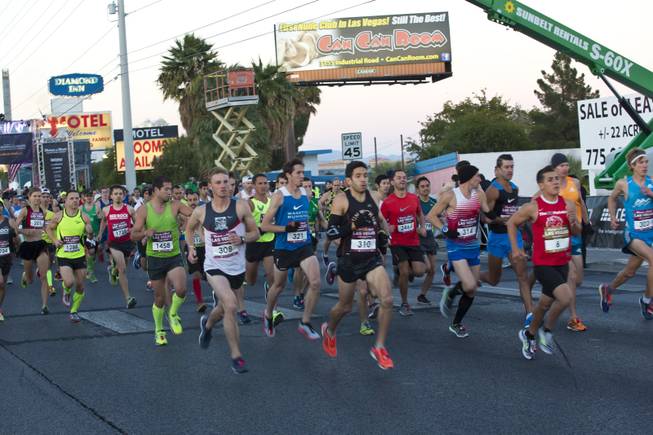 Elite runners take off during the start of the 2014 Rock n Roll Marathon Las Vegas, Sunday Nov. 16, 2014.