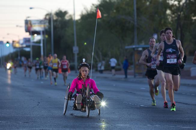 A participant in a specialized hand cycle takes part in the 2014 Rock n Roll Marathon Las Vegas, Sunday Nov. 16, 2014.