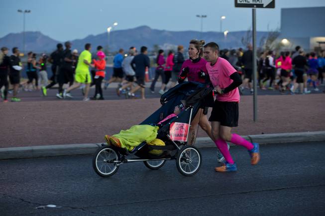 Runners push wheelchairs during the 2014 Rock n Roll Marathon Las Vegas, Sunday Nov. 16, 2014.
