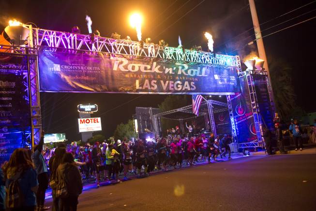 As the sun goes down, runners continue to start in the 2014 Rock n Roll Marathon Las Vegas, Sunday Nov. 16, 2014.