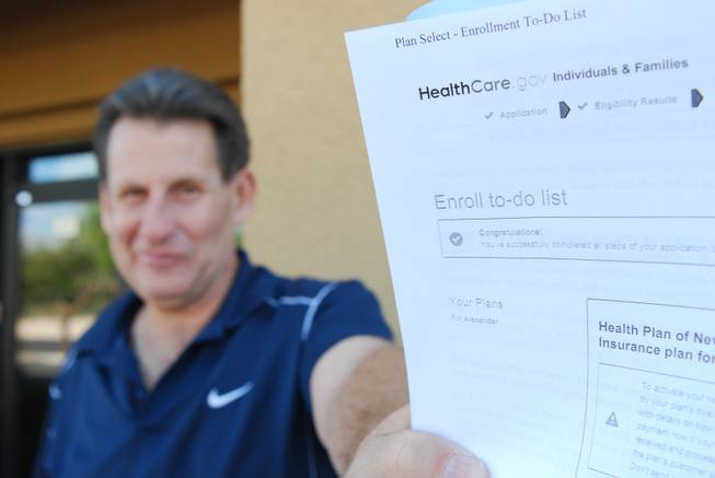 Alex Lombardo, 55, holds a receipt from healthcare.gov that says he successfully enrolled in an insurance plan Saturday, Nov. 15, 2014, the first day of open enrollment for subsidized insurance offered by the Affordable Care Act. Lombardo experienced problems last year after signing up.