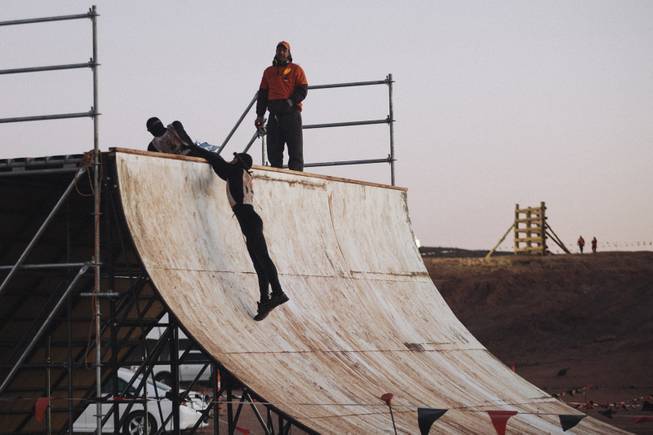 Contestants run up a slick wall during the World's Toughest Mudder competition Sunday, Nov. 16, 2014, at Lake Las Vegas. 