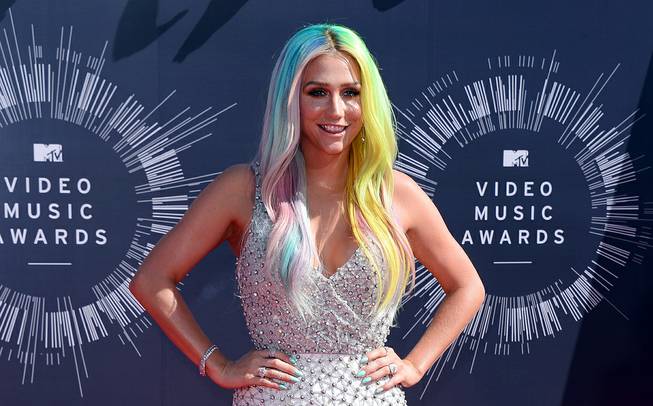 In this Aug. 24, 2014 file photo, Kesha arrives at the MTV Video Music Awards at The Forum in Inglewood, Calif. Attorneys for music producer Lukasz Gottwald, known professionally as Dr. Luke, filed a motion in Los Angeles Superior Court on Monday, Nov. 17, 2014, seeking the dismissal of claims made by the pop singer, Kesha, that she was raped by her mentor. 