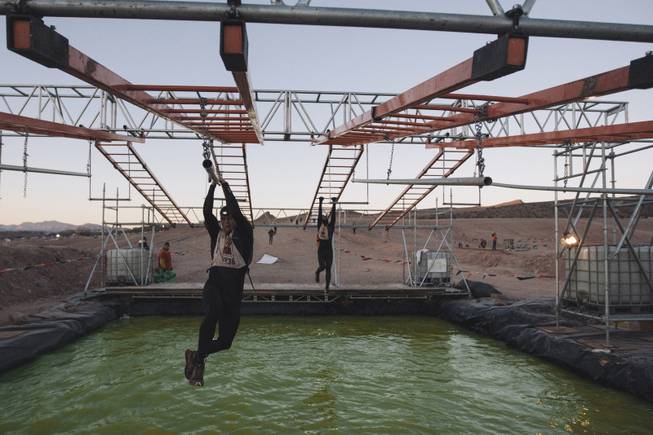 Contestants complete an obstacle during the World's Toughest Mudder competition Sunday, Nov. 16, 2014, at Lake Las Vegas. 