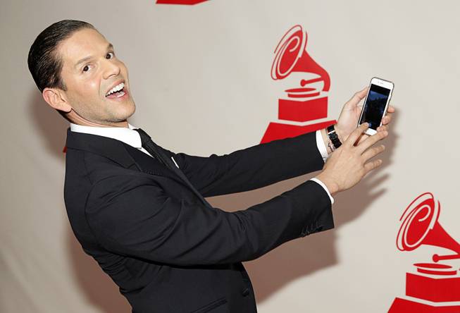 TV personality Rodner Figueroa takes a selfie as he arrives at the 2014 Latin Recording Academy Person of the Year Tribute to Joan Manuel Serrat at the Mandalay Bay Events Center Wednesday, Nov. 19, 2014.
