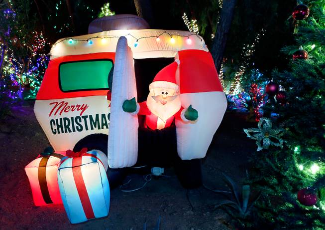 The Cactus Garden at Ethel M Chocolate Factory is lit with holiday lights, including a blow-up and illuminated Santa emerging from his trailer, on Wednesday, Nov. 19, 2014, in Henderson.

