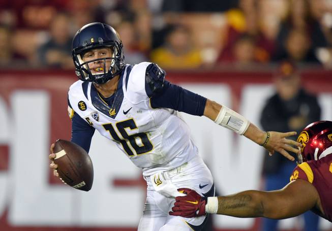 California quarterback Jared Goff, left, tries to pass under pressure from Southern California defensive tackle Antwaun Woods during the first half of an NCAA college football game, Thursday, Nov. 13, 2014, in Los Angeles. (AP Photo/Mark J. Terrill)