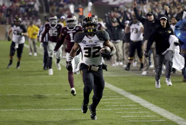 Missouri running back Russell Hansbrough (32) rushes 45 yards for a touchdown against Texas A&M during the second half of an NCAA college football game Saturday, Nov. 15, 2014, in College Station, Texas. (AP Photo/David J. Phillip)