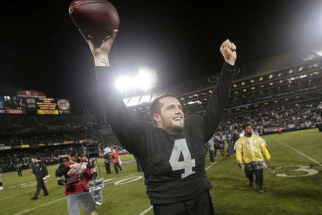 Oakland Raiders quarterback Derek Carr (4) celebrates after the Raiders defeated the Kansas City Chiefs 24-20 in an NFL football game in Oakland, Calif., Thursday, Nov. 20, 2014. 