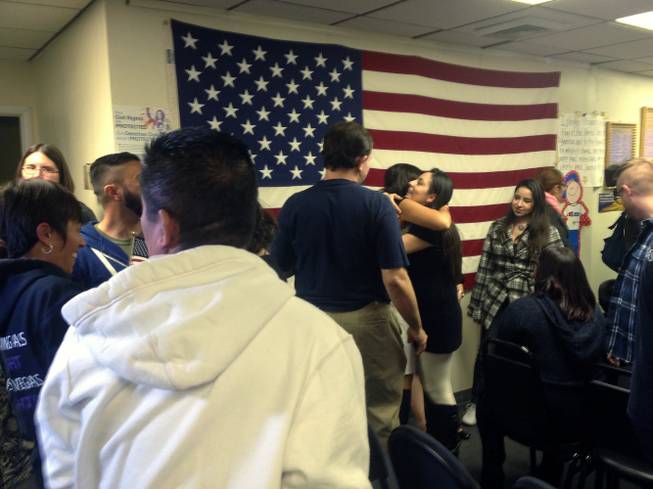 Activists at a Las Vegas community center watch party embrace as they celebrate the news of President Barack Obama's immigration announcement, Thursday, Nov. 20, 2014.