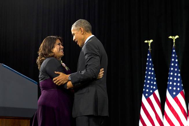 Dreamer Astrid Silva is embraced by President Obama after introducing him at Del Sol High School Friday, Nov. 21, 2014.