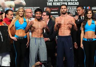 Nov. 22, 2014, Macau, China    ---  (L-R)  Manny Pacquiao of the Philippines and New York's undefeated (20-0) WBO junior welterweight champion Chris Algieri weigh in for their upcoming championship fight. The welterweight bout will take place Saturday, November 22, in Macau, China.