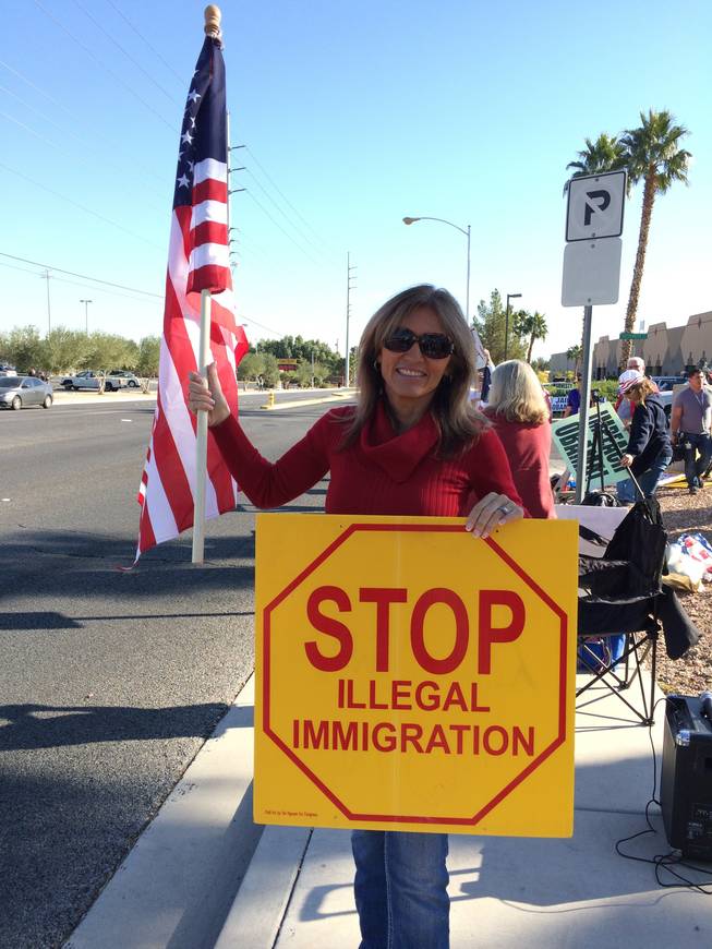 D'Nese Davis, 52, protests outside of Del Sol High School in Las Vegas, Friday, Nov. 21, 2014.