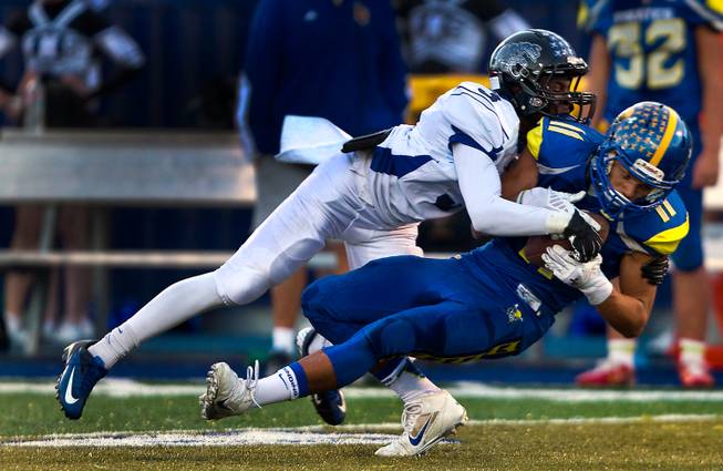 Desert Pines Gianni Breland (3) tackles Moapa Valley's RJ Hubert (11) after a reception during the Division I-A state high school football championship game on Saturday, Nov. 22, 2014.