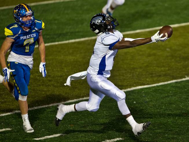 Moapa Valley's Cole Mulcock #7 trails Desert Pines Andre Watts #9 who isn't able to pull in a possible game-winning catch during the Division I-A state high school football championship game on Saturday, November 22, 2014. .