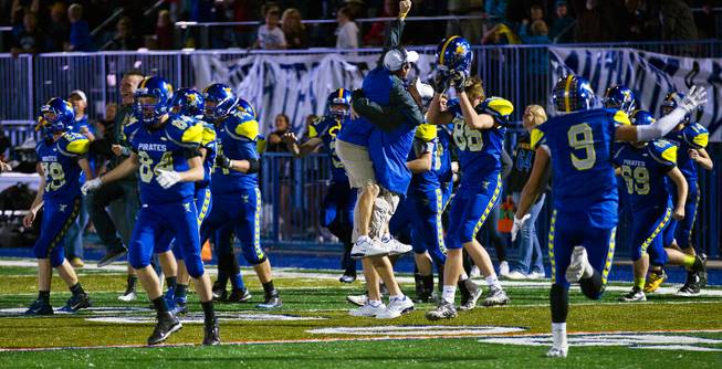 Moapa Valley players celebrate their win over Desert Pines in overtime for the Division I-A state high school football championship on Saturday, November 22, 2014. .