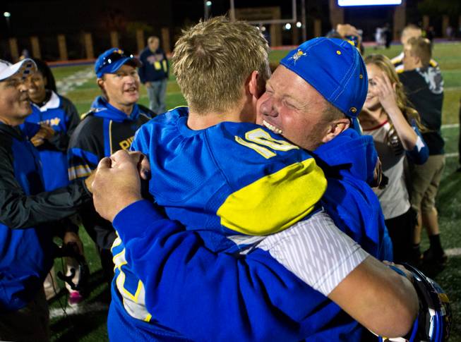 Moapa Valley's QB Zach Hymas #10 shares a hug in celebration of their Division I-A state high school football championship game win on Saturday, November 22, 2014.