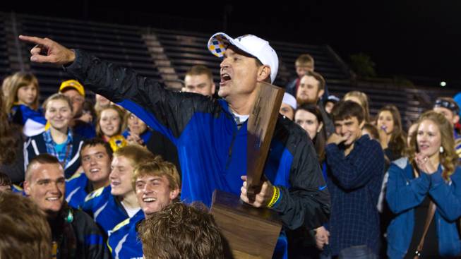 Moapa Valley's head coach Brent Lewis thanks his players, staff and families while holding the winning trophy after the Division I-A state high school football championship game on Saturday, November 22, 2014.