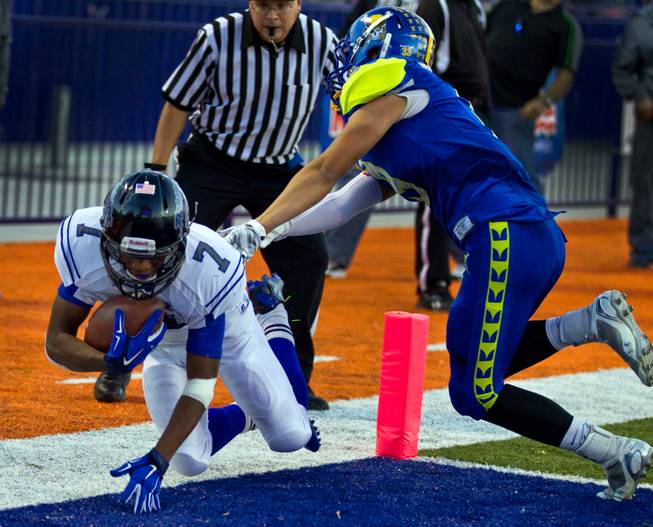 Desert Pines Isaiah Morris #7 gets a hand down in the end zone on a touchdown run over Moapa Valley's Derek Cope #9 during the Division I-A state high school football championship game on Saturday, November 22, 2014. .