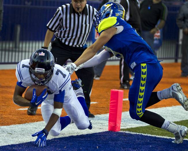 Desert Pines' Isaiah Morris gets a hand down in the end zone on a touchdown run past Moapa Valley's Derek Cope during the Division I-A high school football state championship game Saturday, Nov. 22, 2014.