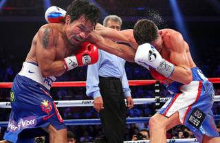 Manny Pacquiao of the Philippines wins a 12-round unanimous decision over WBO junior welterweight champion Chris Algieri in Macau, China Nov. 22, 2014.