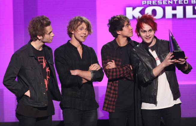 Luke Hemmings, Ashton Irwin, Calum Hood and Michael Clifford of 5 Seconds of Summer accept the award for New Artist of the Year at the 42nd Annual American Music Awards at Nokia Theater L.A. Live on Sunday, Nov. 23, 2014, in Los Angeles. 