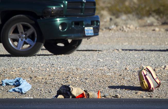 A child's backpack is shown after a man and a baby were hit by a car on South Rainbow Boulevard near Warm Springs Road on Monday, Nov. 24, 2014.
